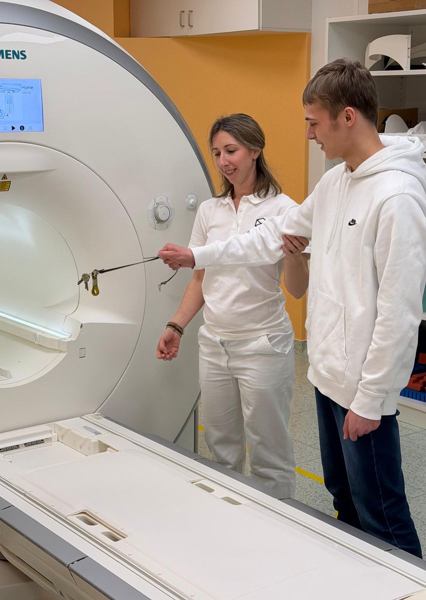 Schüler an einem MRT-Gerät bei einer Führung im Krankenhaus